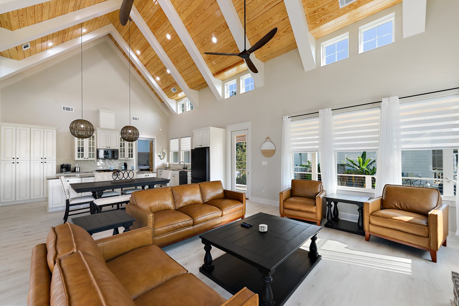 Great room and open kitchen in a custom coastal farmhouse by Full Armour Homes