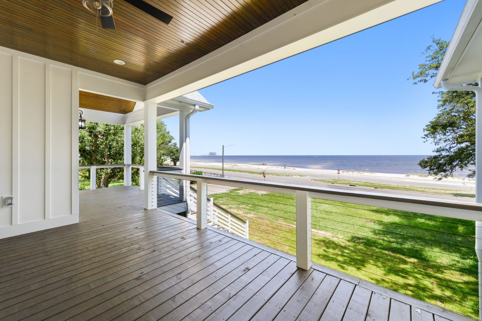 Covered porch with a Gulf view on a waterfront raised home built by Full Armour Homes on the Mississippi Gulf Coast