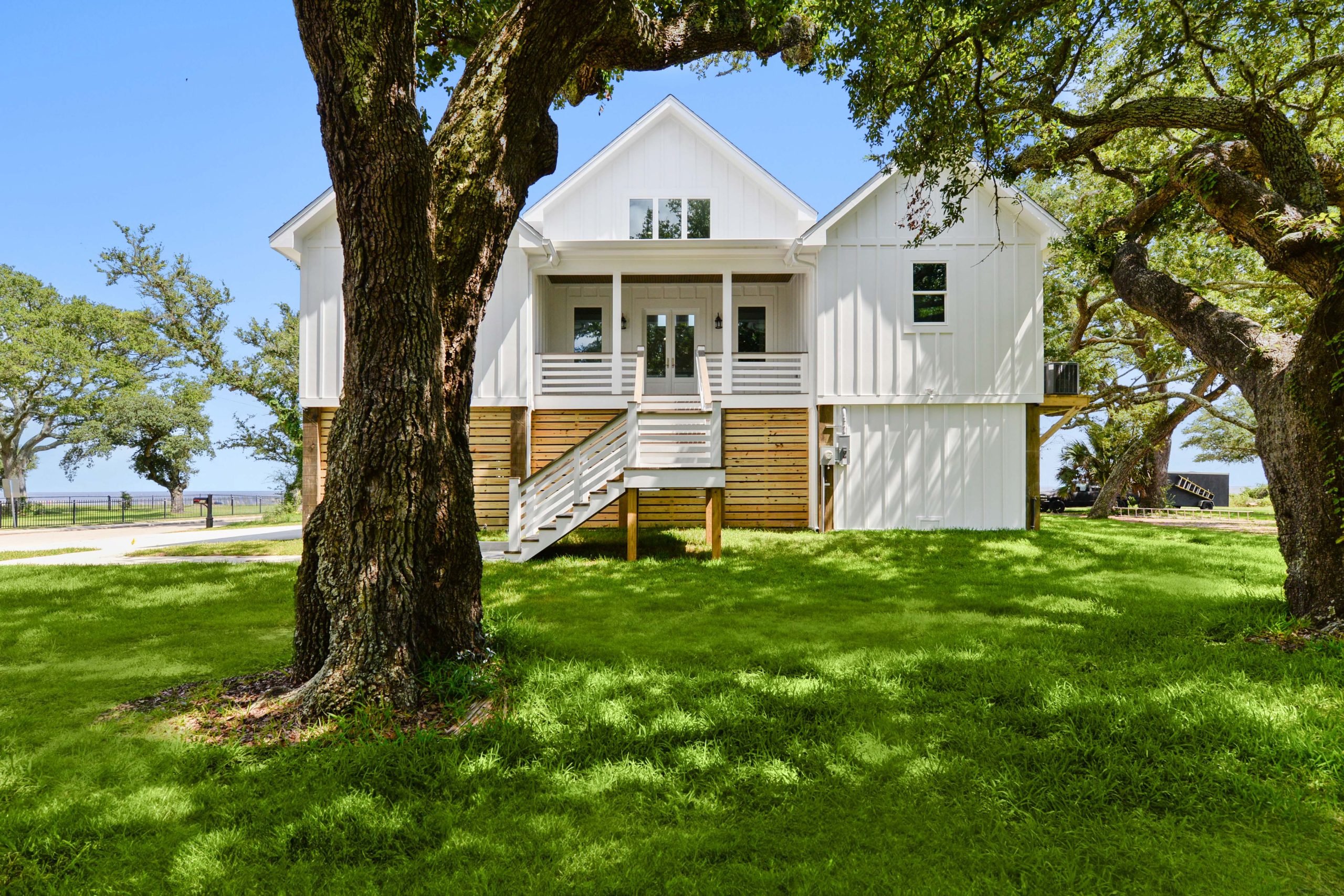 Waterfront raised home among live oaks built by Full Armour Homes